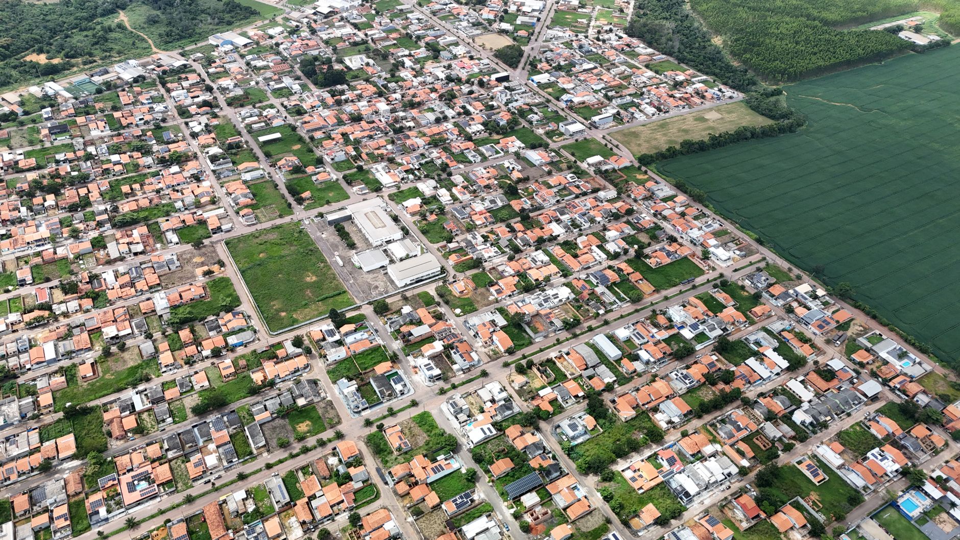 Aerial photograph showcasing the urban landscape of Paragominas, Pará, Brazil, capturing houses, streets, and greenery.