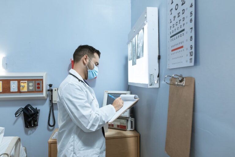 Medical expert analyzes X-ray in hospital room, highlighting healthcare professionalism.