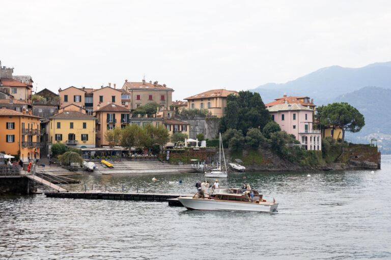 Scenic view of charming village by Lake Como with colorful houses and boats.