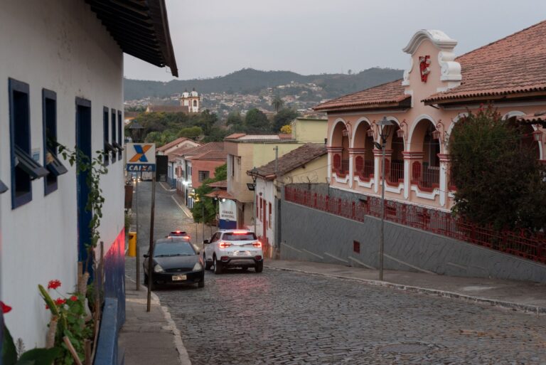 Cobblestone street in Sabará, Brazil with colonial architecture and scenic view.